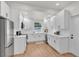 Bright kitchen featuring white cabinetry, stainless steel appliances, and hardwood floors at 919 S Missouri Ave, Lakeland, FL 33803