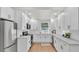 Bright kitchen featuring white cabinetry, stainless steel appliances, and hardwood floors at 919 S Missouri Ave, Lakeland, FL 33803