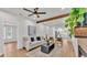 Bright living room featuring a comfortable sofa, modern ceiling fan, and wooden beam accents at 919 S Missouri Ave, Lakeland, FL 33803