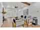 Bright living room featuring a comfortable sofa, modern ceiling fan, and wooden beam accents at 919 S Missouri Ave, Lakeland, FL 33803