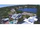 Stunning aerial view of a home with a pool near a lake and city skyline at 934 Lake Elbert Se Dr, Winter Haven, FL 33880