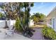 Backyard patio with landscaping, seating and brick pathway leading to lush garden area at 934 Lake Elbert Se Dr, Winter Haven, FL 33880