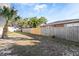 Backyard area featuring a wooden fence, lush trees, and foliage at 934 Lake Elbert Se Dr, Winter Haven, FL 33880