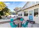 Backyard patio featuring a dining table and chairs, lounge seating, and a glimpse of the home's blue back door at 934 Lake Elbert Se Dr, Winter Haven, FL 33880