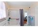 Bathroom featuring a shower with curtain and grab bar for accessibility and built-in shelving at 934 Lake Elbert Se Dr, Winter Haven, FL 33880