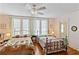 Charming bedroom featuring two beds, hardwood floors, and bright natural light from the windows at 934 Lake Elbert Se Dr, Winter Haven, FL 33880