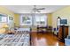 Bright bedroom with two beds, hardwood floors, a desk, and plenty of natural light at 934 Lake Elbert Se Dr, Winter Haven, FL 33880