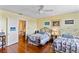 Charming bedroom featuring two beds, hardwood floors, and warm, inviting lighting at 934 Lake Elbert Se Dr, Winter Haven, FL 33880