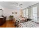 Bedroom featuring two beds, desk, wood floors, ceiling fan, and vintage decor at 934 Lake Elbert Se Dr, Winter Haven, FL 33880