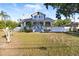 Charming two-story home featuring a screened-in porch and landscaped front yard with mature trees at 934 Lake Elbert Se Dr, Winter Haven, FL 33880