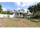 Charming home exterior featuring a white fence, lush trees and a classic design at 934 Lake Elbert Se Dr, Winter Haven, FL 33880
