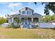 Charming home featuring a large, screened-in front porch and well-manicured landscaping at 934 Lake Elbert Se Dr, Winter Haven, FL 33880