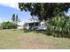 Well-maintained front yard with mature trees and a charming house in the background at 934 Lake Elbert Se Dr, Winter Haven, FL 33880