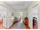 Hallway with hardwood floors, bright lighting, and access to multiple rooms at 934 Lake Elbert Se Dr, Winter Haven, FL 33880