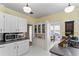 Bright kitchen with white cabinets, grey counters, and a cozy breakfast nook at 934 Lake Elbert Se Dr, Winter Haven, FL 33880