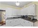 Charming kitchen featuring white cabinets, grey countertops, and retro-style tiling at 934 Lake Elbert Se Dr, Winter Haven, FL 33880