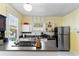 Kitchen featuring stainless steel appliances, grey countertops, and natural light at 934 Lake Elbert Se Dr, Winter Haven, FL 33880
