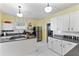 Open kitchen with white cabinets, stainless steel appliances, and gas range at 934 Lake Elbert Se Dr, Winter Haven, FL 33880