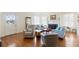 Bright living room featuring hardwood floors, a fireplace, and cozy seating for a comfortable atmosphere at 934 Lake Elbert Se Dr, Winter Haven, FL 33880