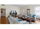 Spacious living room with hardwood floors, comfortable seating, and a large screen television at 934 Lake Elbert Se Dr, Winter Haven, FL 33880