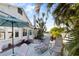 Outdoor patio area with lounge chairs, umbrella, dining table, and grill; perfect for relaxing and entertaining near the water at 934 Lake Elbert Se Dr, Winter Haven, FL 33880