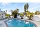Sparkling backyard pool surrounded by patio area, lounge chairs, lush landscaping, and privacy fence at 934 Lake Elbert Se Dr, Winter Haven, FL 33880