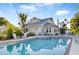Refreshing in-ground pool surrounded by comfortable lounge seating and lush landscaping at 934 Lake Elbert Se Dr, Winter Haven, FL 33880