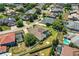 Beautiful aerial view of the home with a screened in patio and lush trees in a quiet neighborhood at 942 Hanover Way, Lakeland, FL 33813