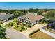 Charming aerial view of a grey house with manicured lawn, lovely landscaping and a long driveway at 942 Hanover Way, Lakeland, FL 33813
