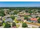Desirable community view with charming gray home, lush greenery, beautiful landscaping and mature trees at 942 Hanover Way, Lakeland, FL 33813
