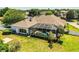 A bird's-eye view highlights a home with a screened-in pool and a beautifully landscaped yard at 942 Hanover Way, Lakeland, FL 33813