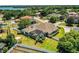 A panoramic view showcases a home with a screened-in pool in a serene neighborhood setting at 942 Hanover Way, Lakeland, FL 33813