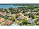 Aerial view showcasing a waterfront community with stunning lake views and lush landscaping at 942 Hanover Way, Lakeland, FL 33813