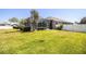 A spacious grassy backyard featuring an enclosed pool and white vinyl fence at 942 Hanover Way, Lakeland, FL 33813