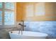 Soaking tub is situated with privacy shutters and beautiful marble detail at 942 Hanover Way, Lakeland, FL 33813