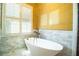 Relax in style in this soaking tub with plantation shutters and stunning design details at 942 Hanover Way, Lakeland, FL 33813