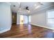 Primary bedroom with hardwood floors, tray ceilings, and barn-style door leading to en suite bath at 942 Hanover Way, Lakeland, FL 33813
