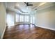 Bedroom with hardwood floors, tray ceilings and natural light from the many windows at 942 Hanover Way, Lakeland, FL 33813