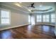 Spacious bedroom with tray ceiling, fan, wood floors, and lots of natural light at 942 Hanover Way, Lakeland, FL 33813