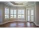 Bright bedroom with tray ceiling, wood floors, plantation shutters, and door to exterior at 942 Hanover Way, Lakeland, FL 33813