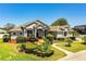 Beautiful single story home featuring mature landscaping, covered entry, and walkway at 942 Hanover Way, Lakeland, FL 33813