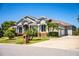 Beautiful home with lush landscaping, a well-maintained lawn, and an attached two-car garage at 942 Hanover Way, Lakeland, FL 33813