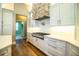 Gourmet kitchen with stainless steel appliances, quartz countertops and custom vent hood at 942 Hanover Way, Lakeland, FL 33813