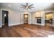 Spacious living room boasting hardwood floors, a modern ceiling fan, and a cozy fireplace at 942 Hanover Way, Lakeland, FL 33813