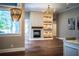 Bright living room features a modern fireplace, hardwood floors, and elegant lighting fixtures at 942 Hanover Way, Lakeland, FL 33813