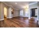 Open living space with hardwood floors, built-in shelving, and natural light streaming in at 942 Hanover Way, Lakeland, FL 33813
