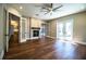Bright living room featuring hardwood floors, fireplace, and large windows with ample natural light at 942 Hanover Way, Lakeland, FL 33813
