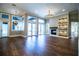 Open-concept living room with generous windows, fireplace, and contemporary chandelier at 942 Hanover Way, Lakeland, FL 33813