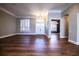 Spacious living room featuring hardwood floors, plantation shutters, and modern light fixture at 942 Hanover Way, Lakeland, FL 33813