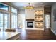 Open concept living area with a fireplace, hardwood floors and sliding doors at 942 Hanover Way, Lakeland, FL 33813